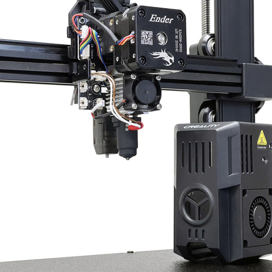 A close-up view of a 3D printer's extruder assembly. The machine, identified as a Creality Ender 3 V3 KE, features the Micro Swiss FlowTech Hotend for Creality Ender 3 V3 KE and various wires. Positioned on a metal rail, with a fan and additional parts visible below, it ensures precise printing with its leak-proof nozzle.