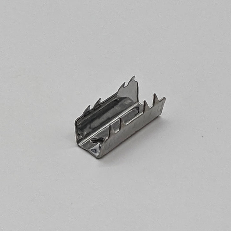 A small, metallic rectangular bracket with jagged edges on the longer sides. The 3docity Belt Clamp for GT2-6mm Open Timing Belt (1pcs) is positioned on a plain, light gray surface, ready to secure a GT2-6mm open timing belt from a 3D printer.